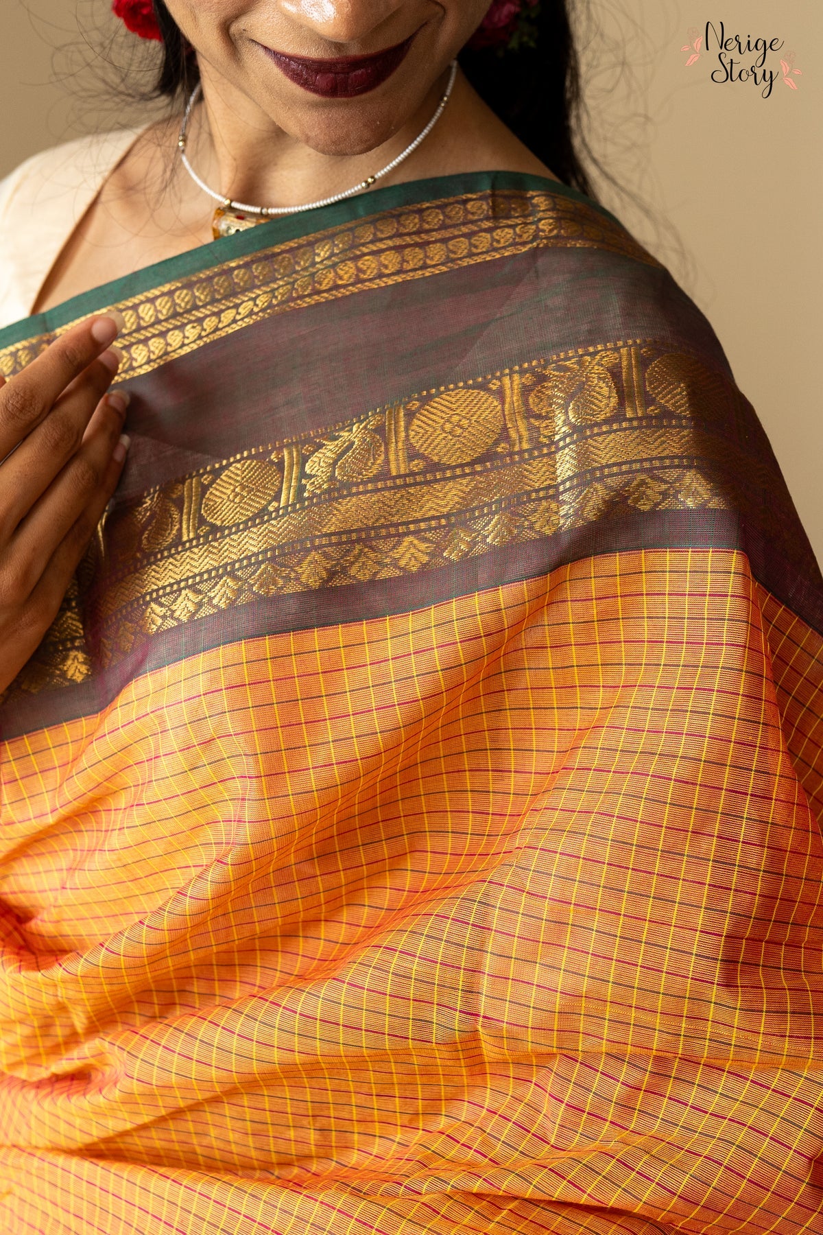 A lovely chequered orange Chettinad cotton saree with a dual-shaded green and pink ganga-jamuna border and a vintage gold zari border