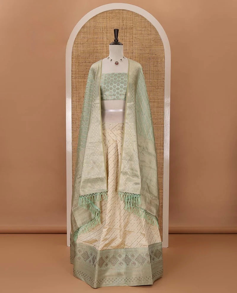 Cream semi-banaras material chudidar,leheriya zari skirt,contrast pista green zari & swarovski stonework border,jacquard blouse & zari weave dhavani