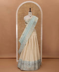 Cream semi-banaras material chudidar,leheriya zari skirt,contrast sea blue zari & swarovski stonework border,jacquard blouse & zari weave dhavani