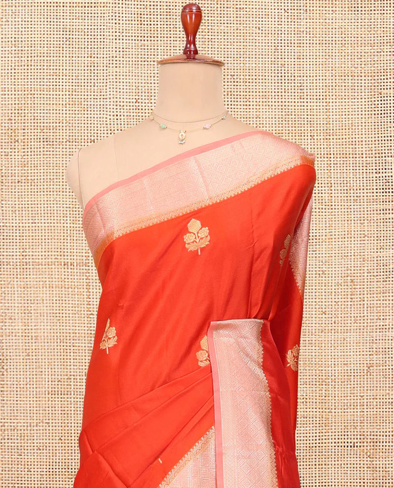 Orange Satin Silk Saree, Delicately Woven with Floral Buttas All Over Its Body, Complemented by a Contrast Border of Jaal Designs, Pallu of Jaal Designs in Zari, and Paired with a Contrast Blouse