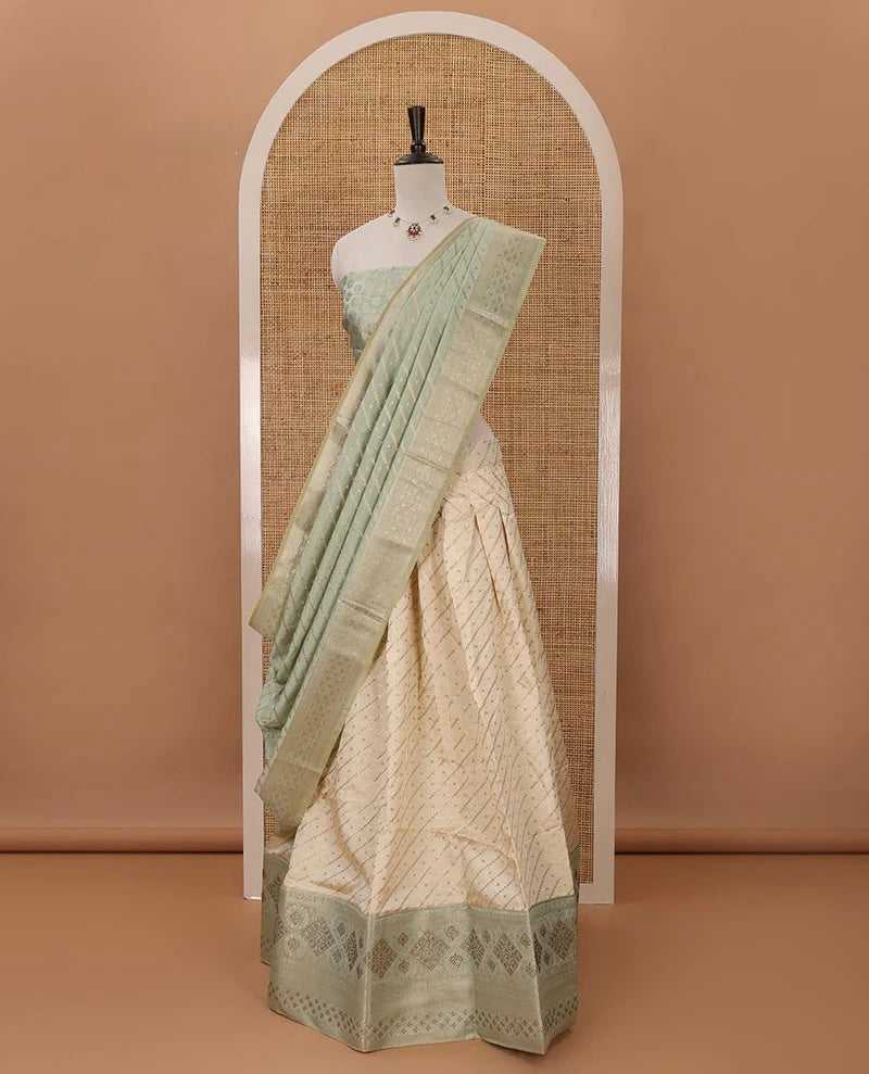 Cream semi-banaras material chudidar,leheriya zari skirt,contrast pista green zari & swarovski stonework border,jacquard blouse & zari weave dhavani