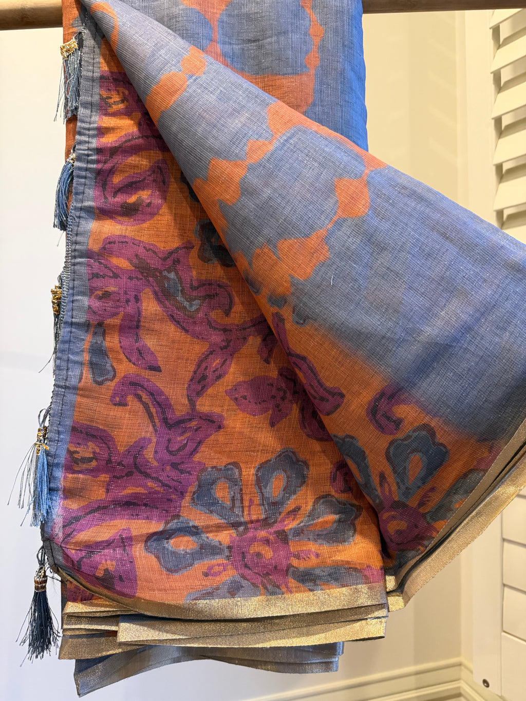 Grey Linen Cotton Saree, Detailed with Shibori Printed on Its Body, Subtle Piping Border, Pallu Features Floral Print, and Paired with a Contrast Floral Printed Blouse