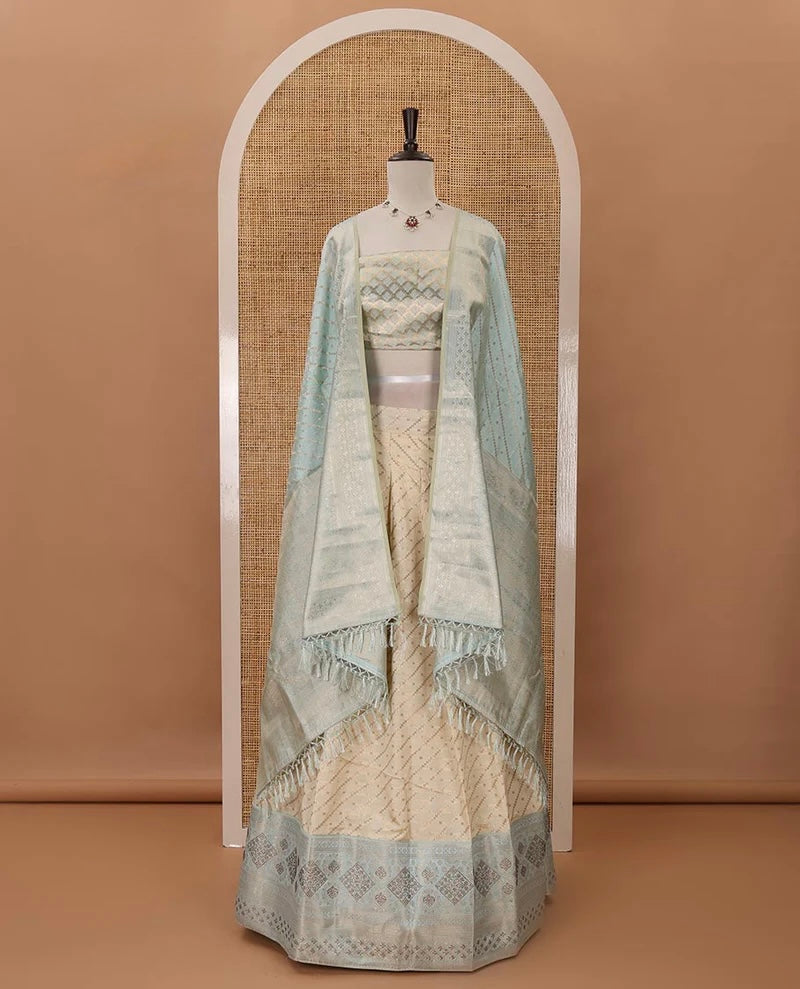 Cream semi-banaras material chudidar,leheriya zari skirt,contrast sea blue zari & swarovski stonework border,jacquard blouse & zari weave dhavani