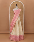 Cream semi-banaras material chudidar,leheriya zari skirt,contrast onion pink zari & swarovski stonework border,jacquard blouse & zari weave dhavani